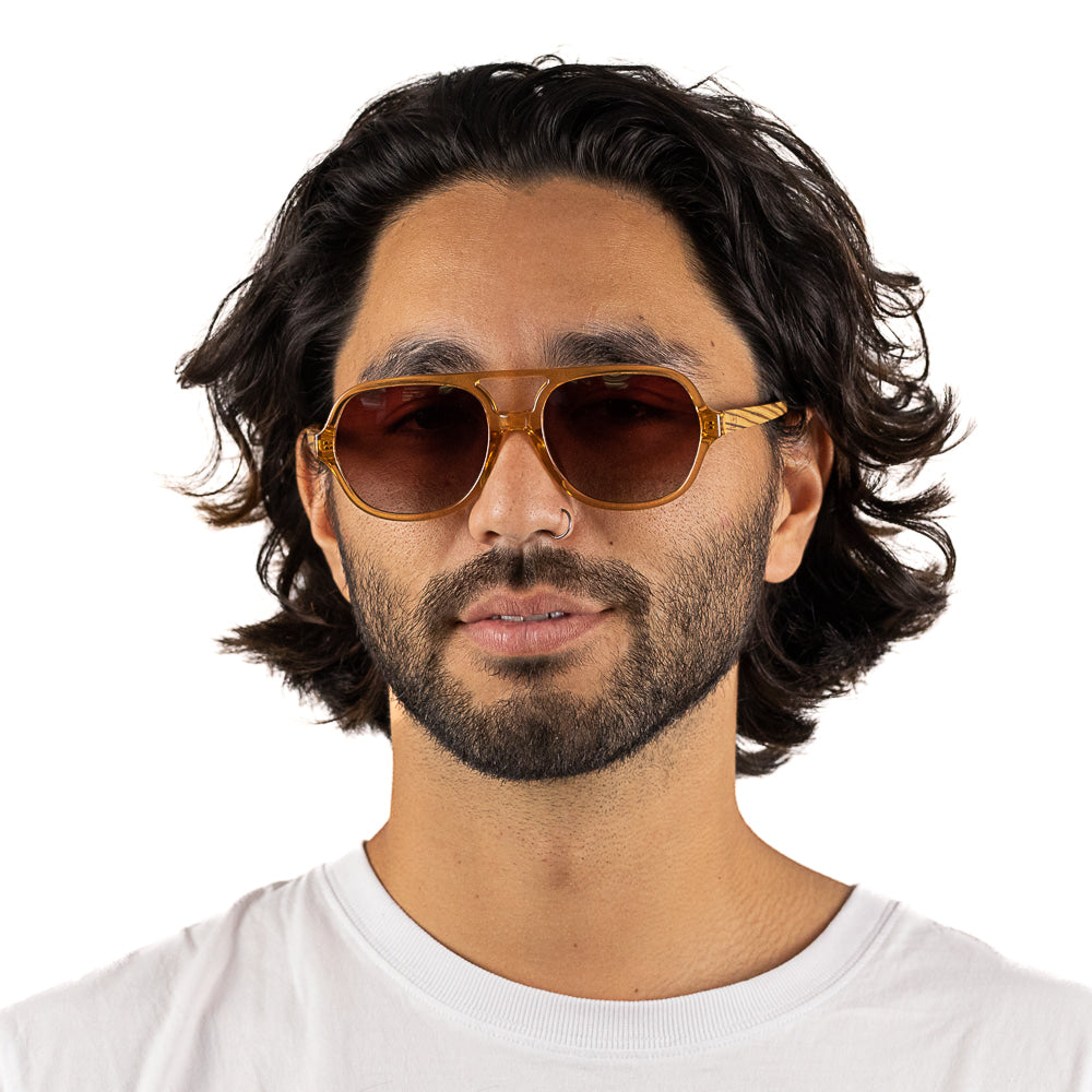 A man with dark curly hair wearing the Billy sunglasses, front on