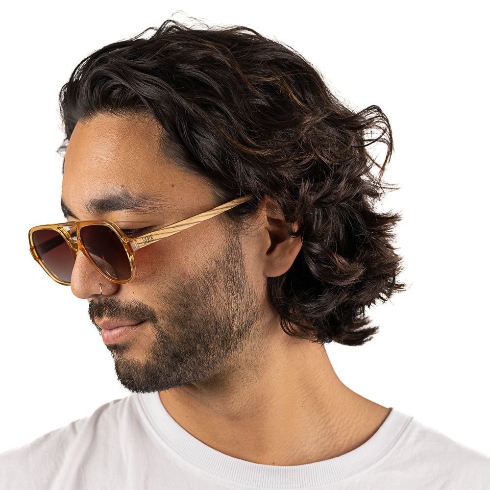 A man with dark curly hair in profile wearing the Billy sunglasses