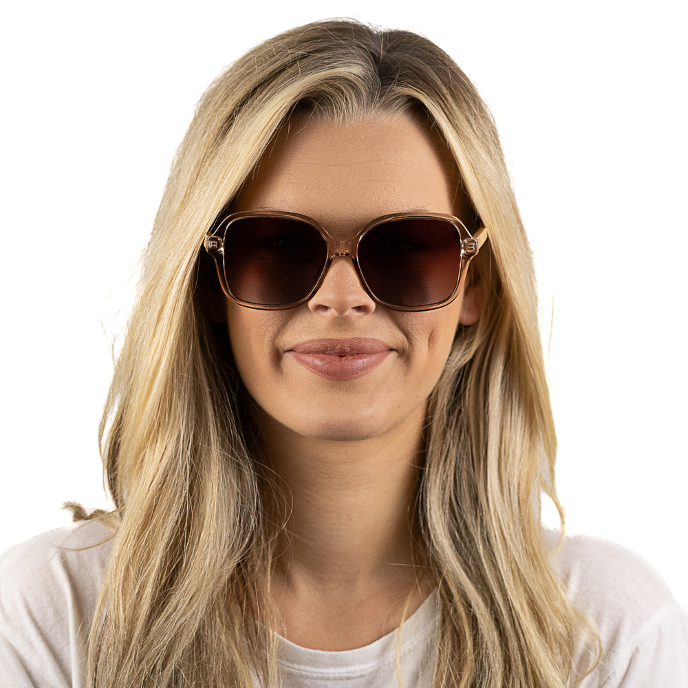 Blonde model facing the camera in the Scarlett sunglasses, smiling