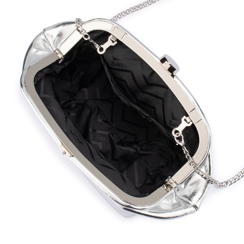 The clutch open on its silver frame, showing a black patterned lining