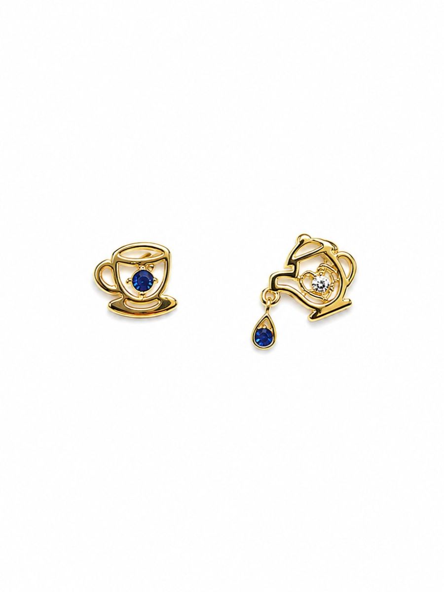 Odd pair of gold-tone studs: a teacup and saucer with a blue stone, and a teapot with a blue teardrop falling from the spout