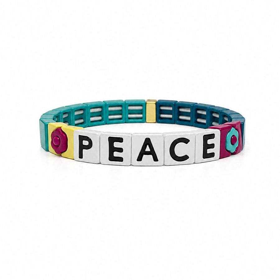 Teal tile bracelet with five white tiles spelling PEACE in black, between a magenta flower tile and a teal flower tile