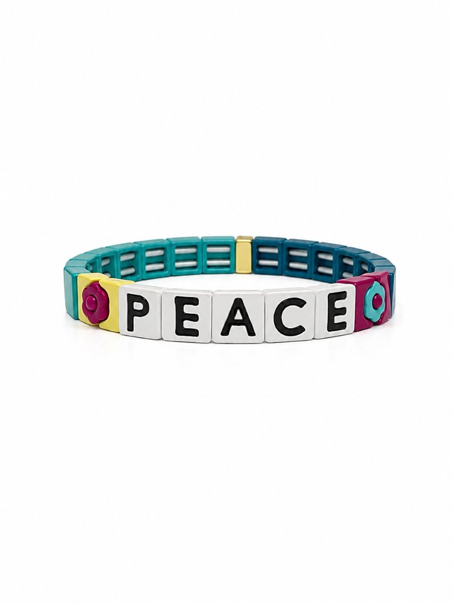 Teal tile bracelet with five white tiles spelling PEACE in black, between a magenta flower tile and a teal flower tile