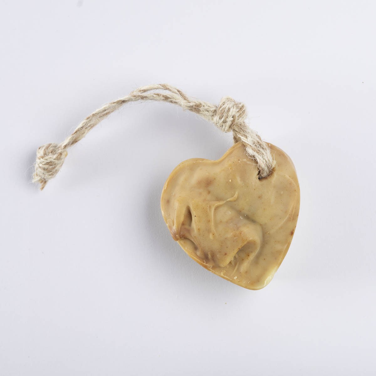 A tan heart soap with a jute hanging loop