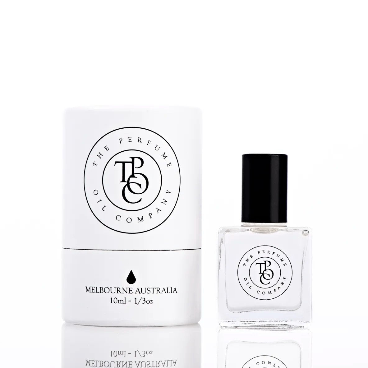 The Perfume Oil Company white gift cylinder beside a 10 ml bottle of perfume oil, bottle to the right of the cylinder
