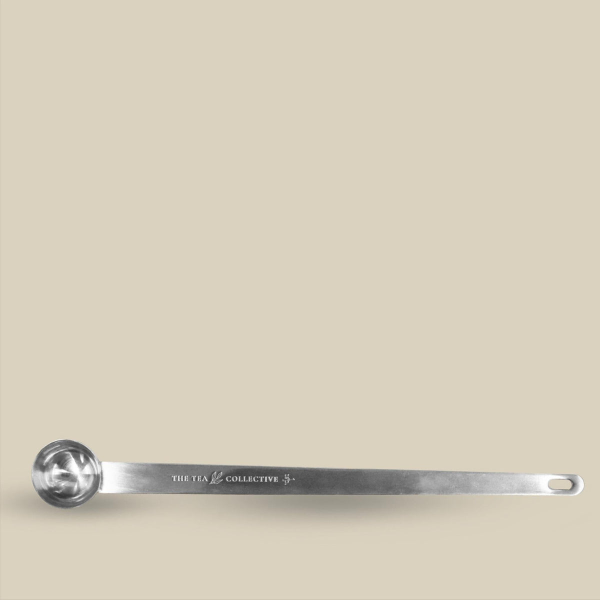 Long silver tea spoon engraved with The Tea Collective branding