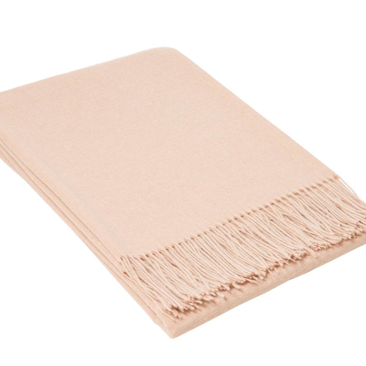 Blush pink merino wool blend throw folded neatly with a knotted fringe along one edge