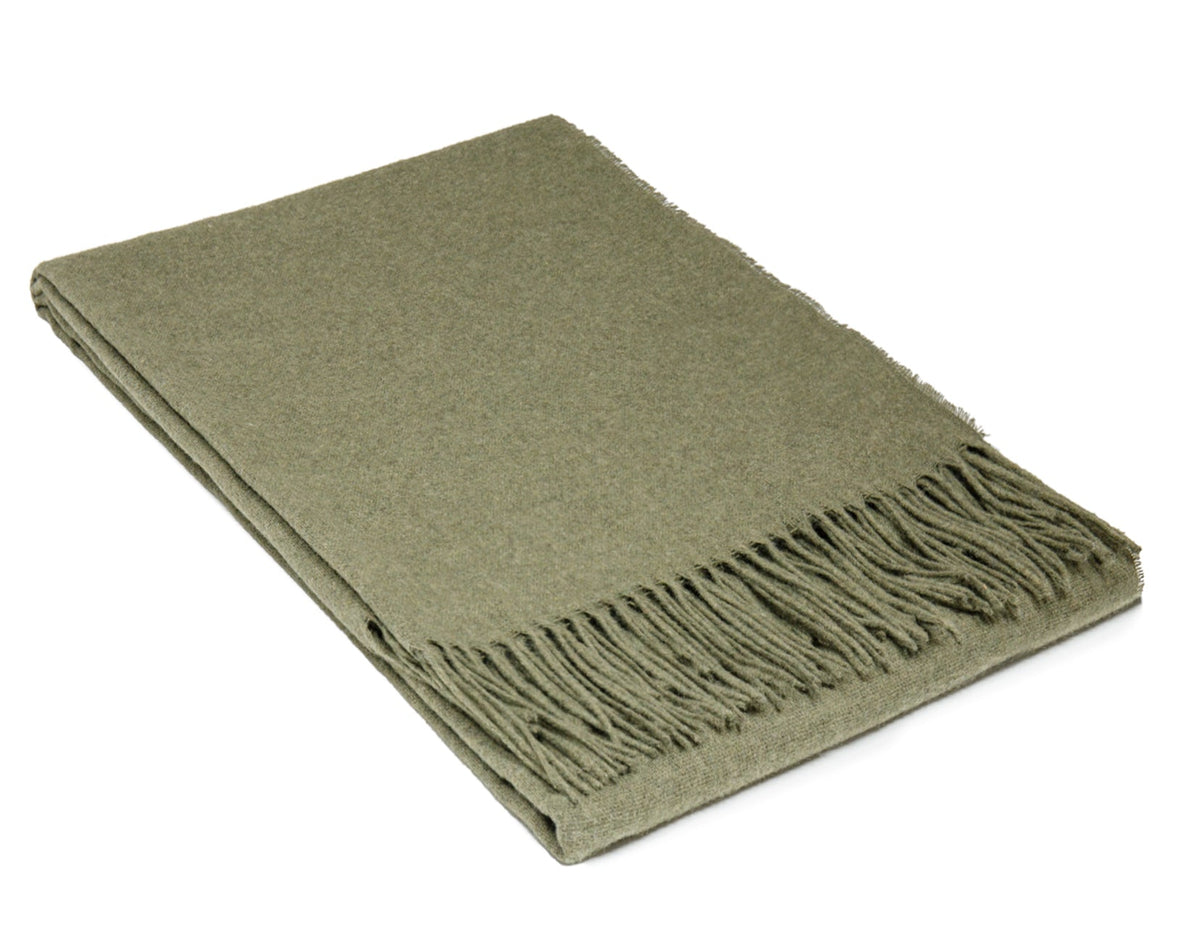 Olive green merino wool blend throw folded neatly with a knotted fringe along one edge