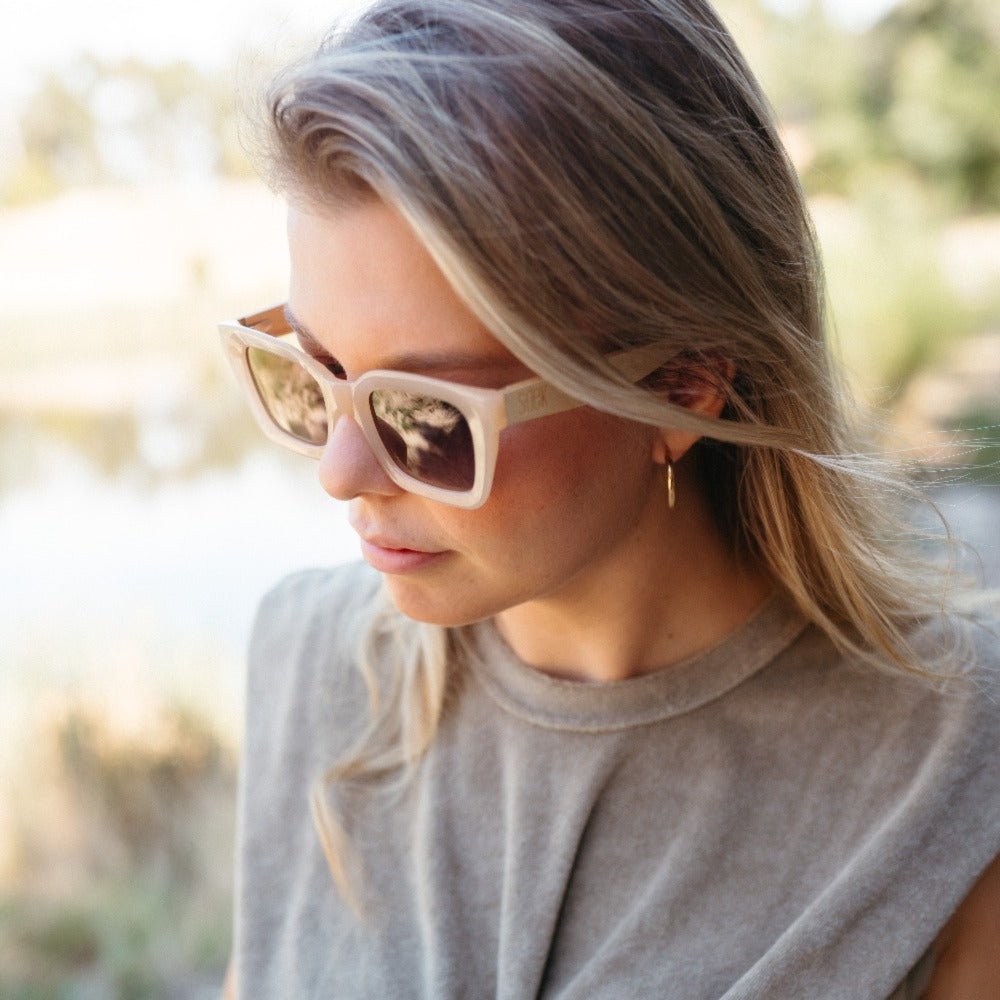 A woman with blonde hair in profile wearing the Zahra sunglasses