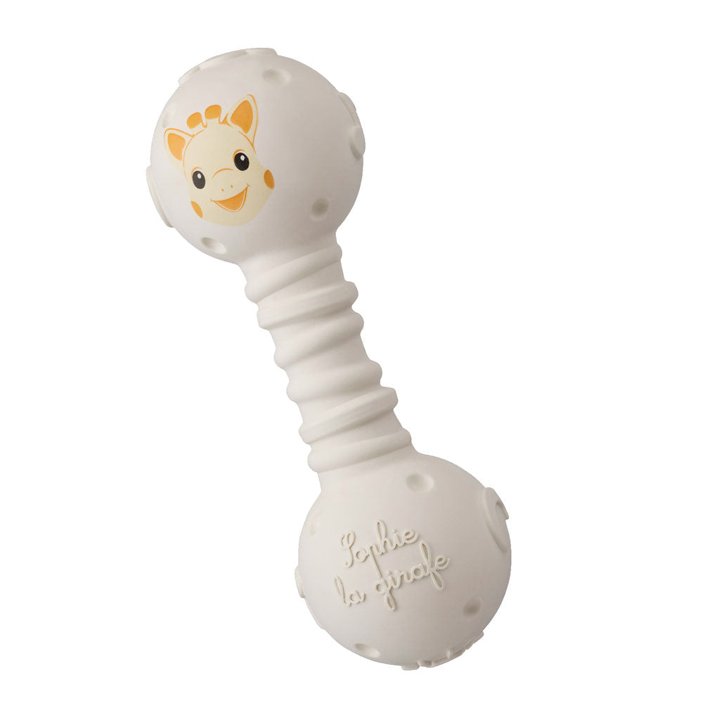 Sophie la Girafe teething rattle in cream natural rubber, dumbbell shaped, with Sophie's face moulded into the top ball and a ribbed handle.