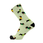 Single lime green crew sock with a black toe, printed with dachshunds in small knitted jumpers.