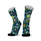 Pair of deep teal socks with black toes, printed with tents, lanterns, billy cans, pocket knives and camp chairs.