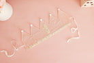 First birthday crown laid flat showing its adjustable ribbon ties