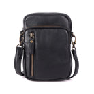 Black cross body bag from the front, zip pockets across the top and down the front