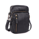 Black cross body bag angled to show the side and the strap clip
