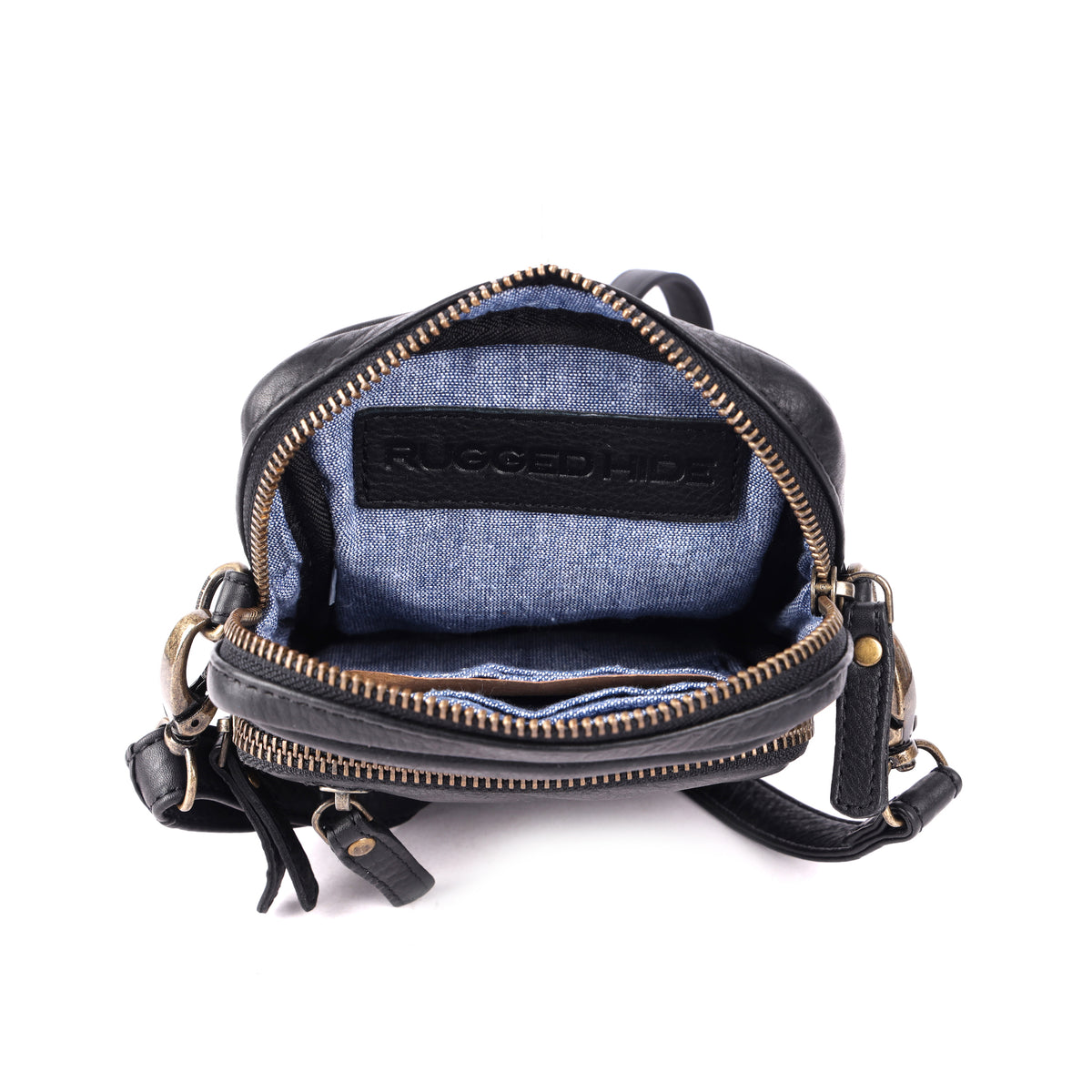 The black bag unzipped from above, showing the blue fabric lining, card slots and a stamped leather tab
