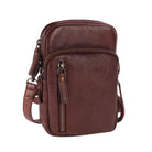 Brown cross body bag angled to show the side and the strap clip