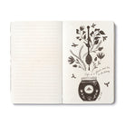 Open journal with lined pages beside a cream page of a honey pot and dipper among flowering stems and bees, lettered: life is a flower and love is its honey