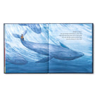 Open spread of a large blue whale underwater beneath a small figure