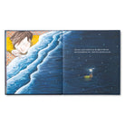 Open spread of a sleeping child beside a moonlit shoreline