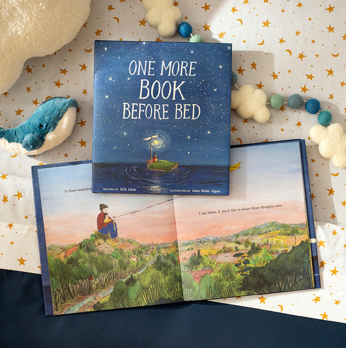 The book styled on star-patterned fabric with a bead garland and a small plush whale