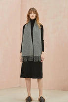 Light Charcoal grey scarf draped over a black dress, front view