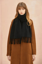 Close view of the Ebony black scarf over a brown coat