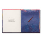 Open spread with a short passage beside a deep blue painting of a fish beneath the surface