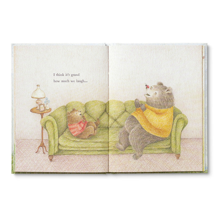 Open spread of the two bears sitting together on a green sofa
