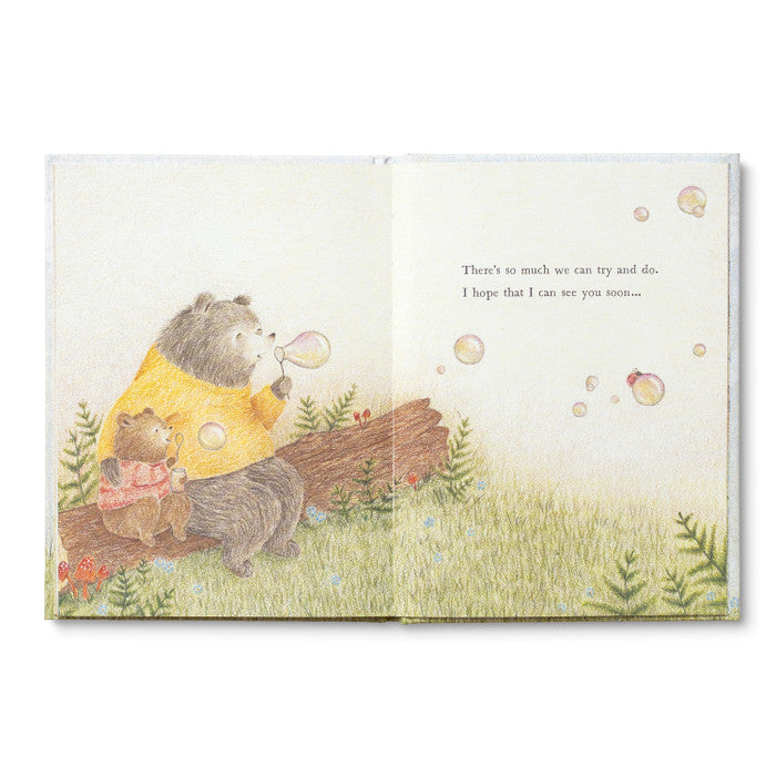 Open spread of the bears blowing bubbles beside a fallen log