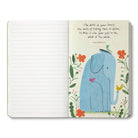 Open journal with a breakout page of a blue elephant among flowers on the work of your heart