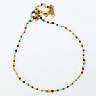 Fine gold bracelet with multi-coloured gemstone beads on a delicate chain