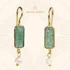 Euro Gold earrings with green chalcedony bars and pearl drops, on patterned cream backdrop