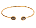 Euro Gold cuff bangle with two smoky brown gems on black background