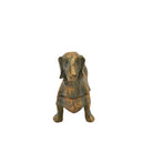 Antique gold dachshund figurine facing forward, seen head-on with ears hanging either side.