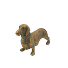 Antique gold dachshund figurine at a three-quarter angle facing left.