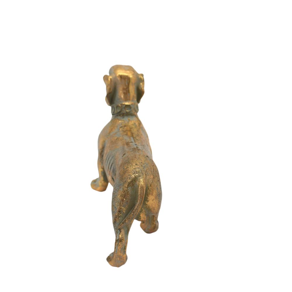 Antique gold dachshund figurine seen from above and behind, standing on all four legs.