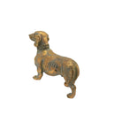 Antique gold dachshund figurine at a three-quarter angle facing right.