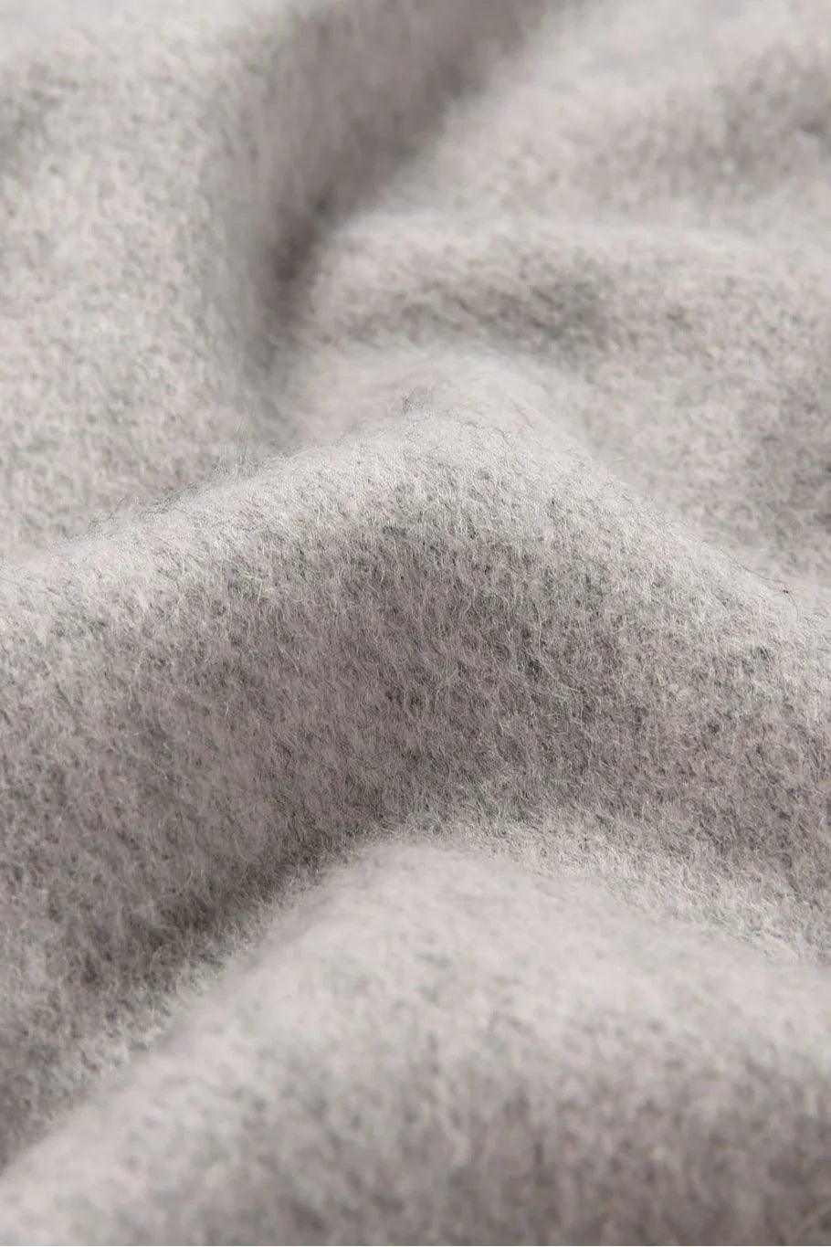 Texture close-up of the Quartz Pink pale grey merino