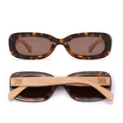 Two pairs of Vibe sunglasses in toffee tortoise, one front-on and one folded, showing the pale maple arms