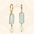 Euro Gold earrings with aqua chalcedony bars and pearl drops, on patterned cream backdrop