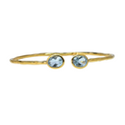 Fine Euro Gold cuff bangle with two pale blue topaz gems