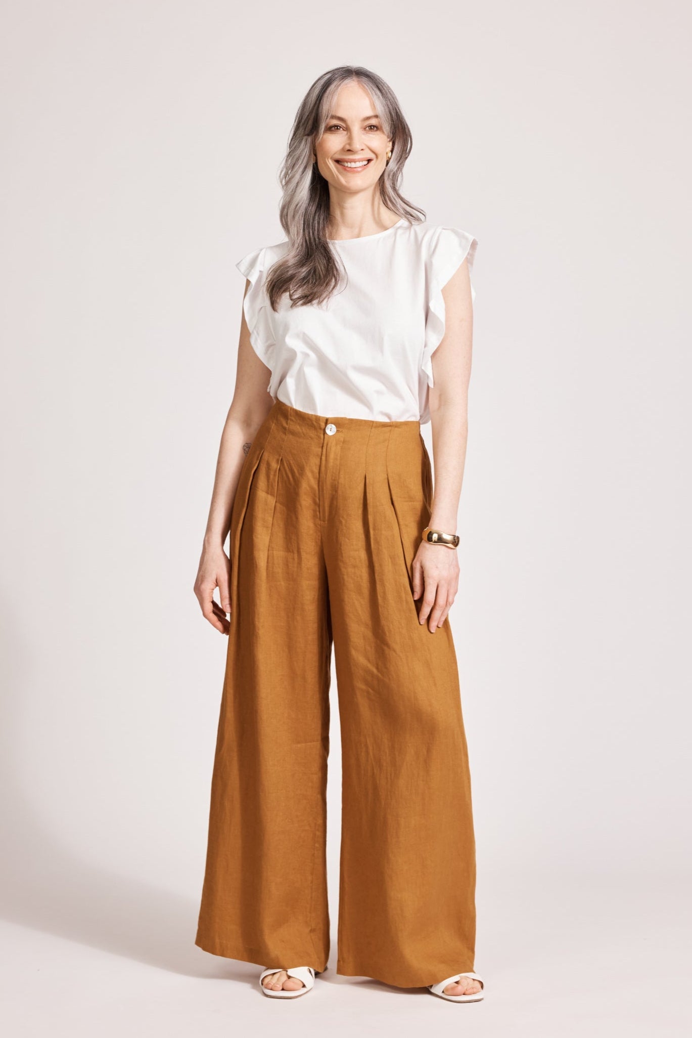 Model in the caramel linen Miramar Palazzo Pant with a white frill top