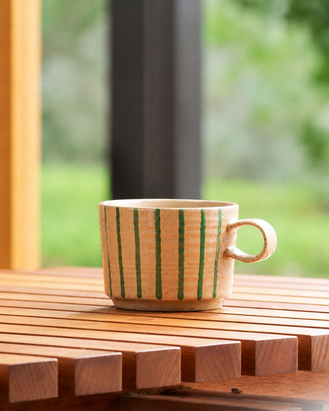 Archive mug in Olive on a slatted timber table by a window
