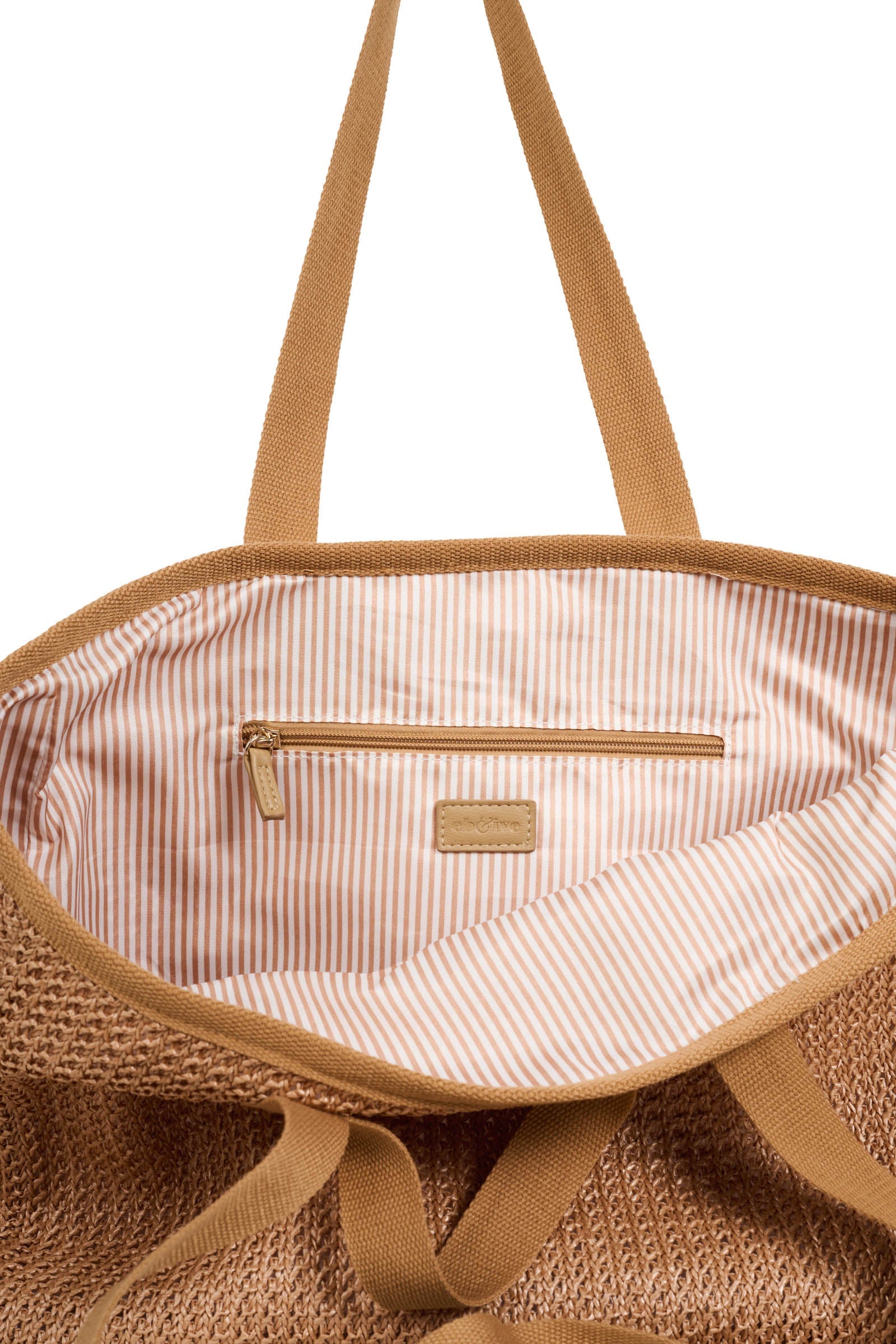 Inside the Artemis Beach Bag showing striped lining and zip pocket