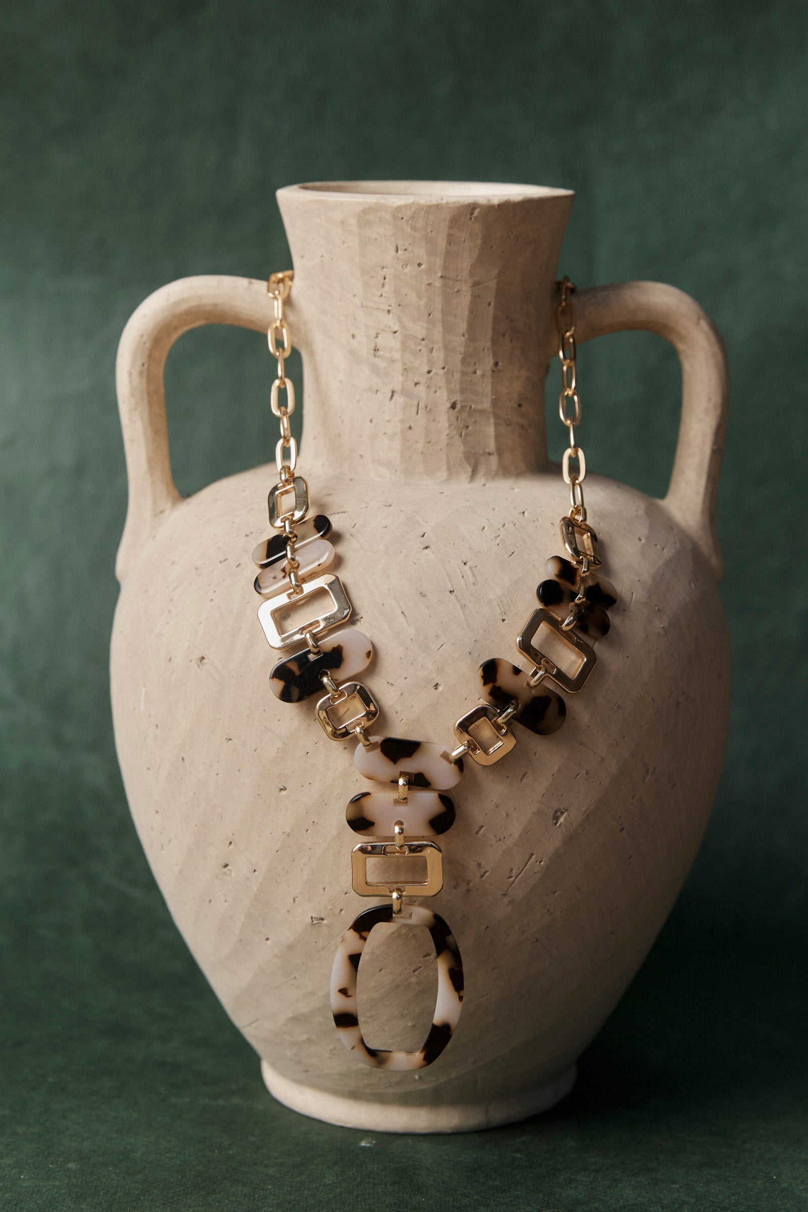 Nomad Chain draped over a stone urn