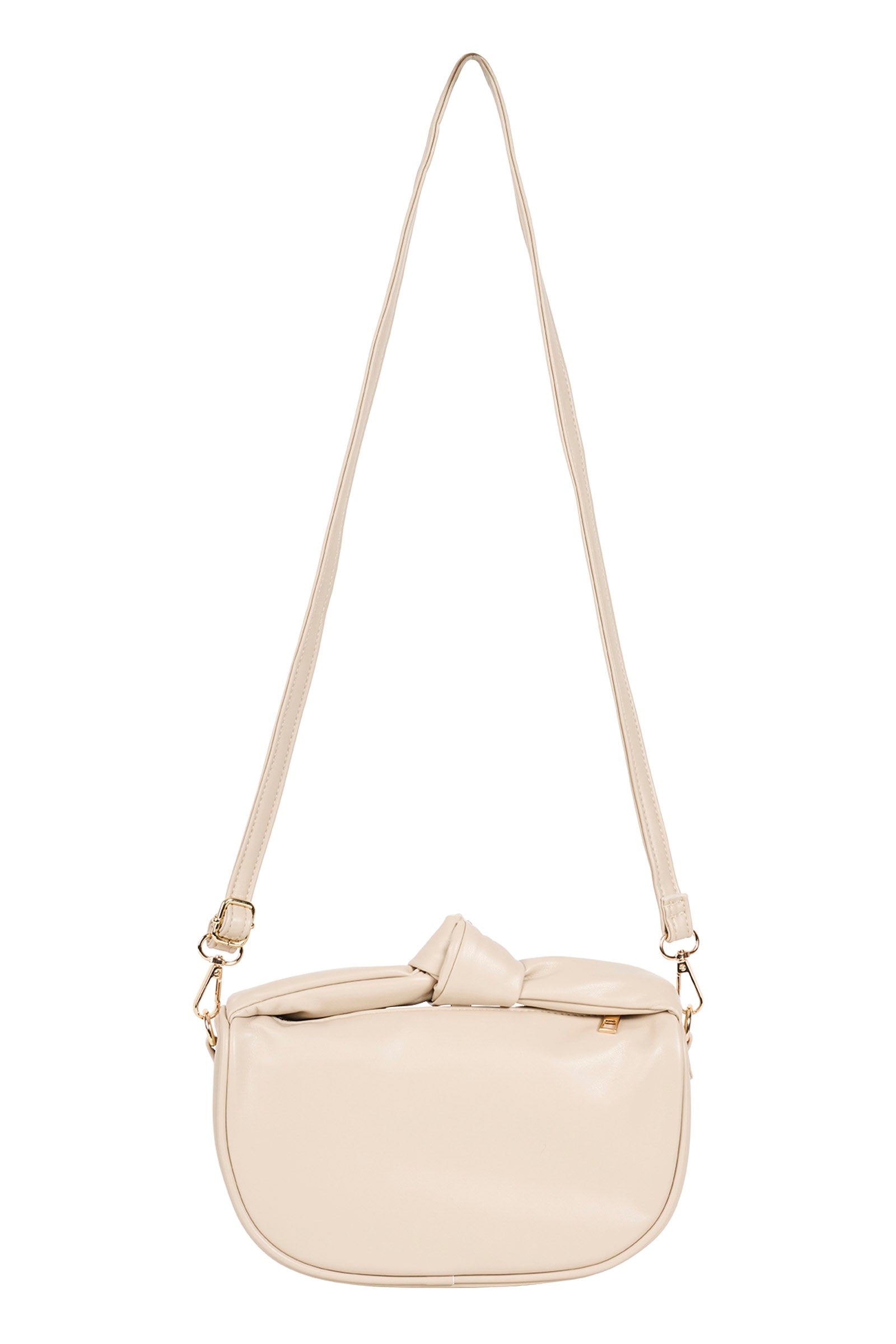 Zala Bag in Bisque hanging by its long crossbody strap
