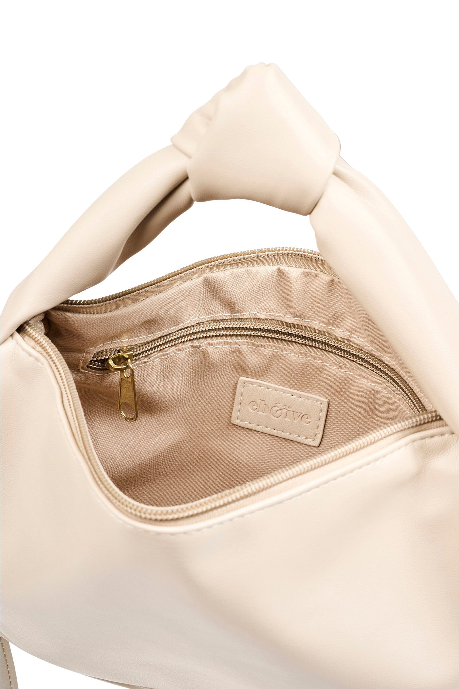 Open bisque Zala Bag showing lined interior and zip pocket