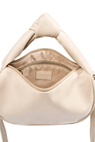 Knot handle detail of the open bisque Zala Bag