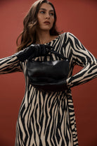 Model wearing the black Zala Bag across the body